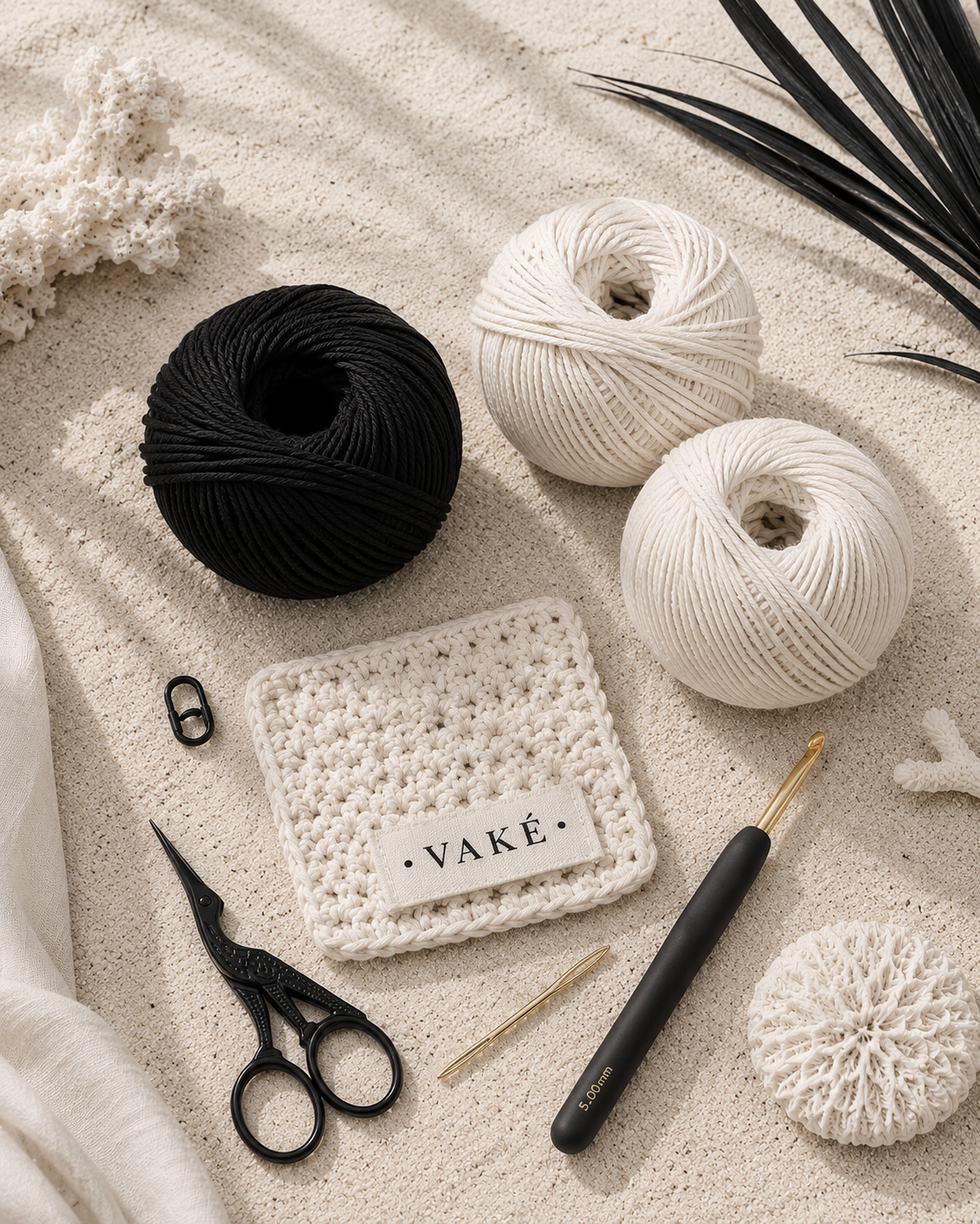 VAKÉ crochet materials including cotton yarn, hook, scissors, and a branded crochet swatch